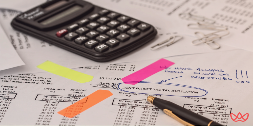 Documents with annotations and a calculator, representing preparation for interview questions for a bookkeeper.