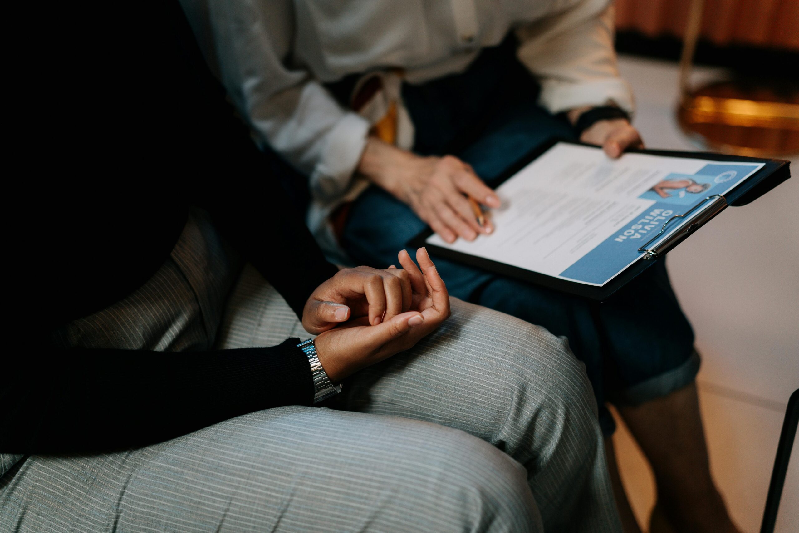 Professional engaging with a free AI resume builder on a digital tablet during a consultation.