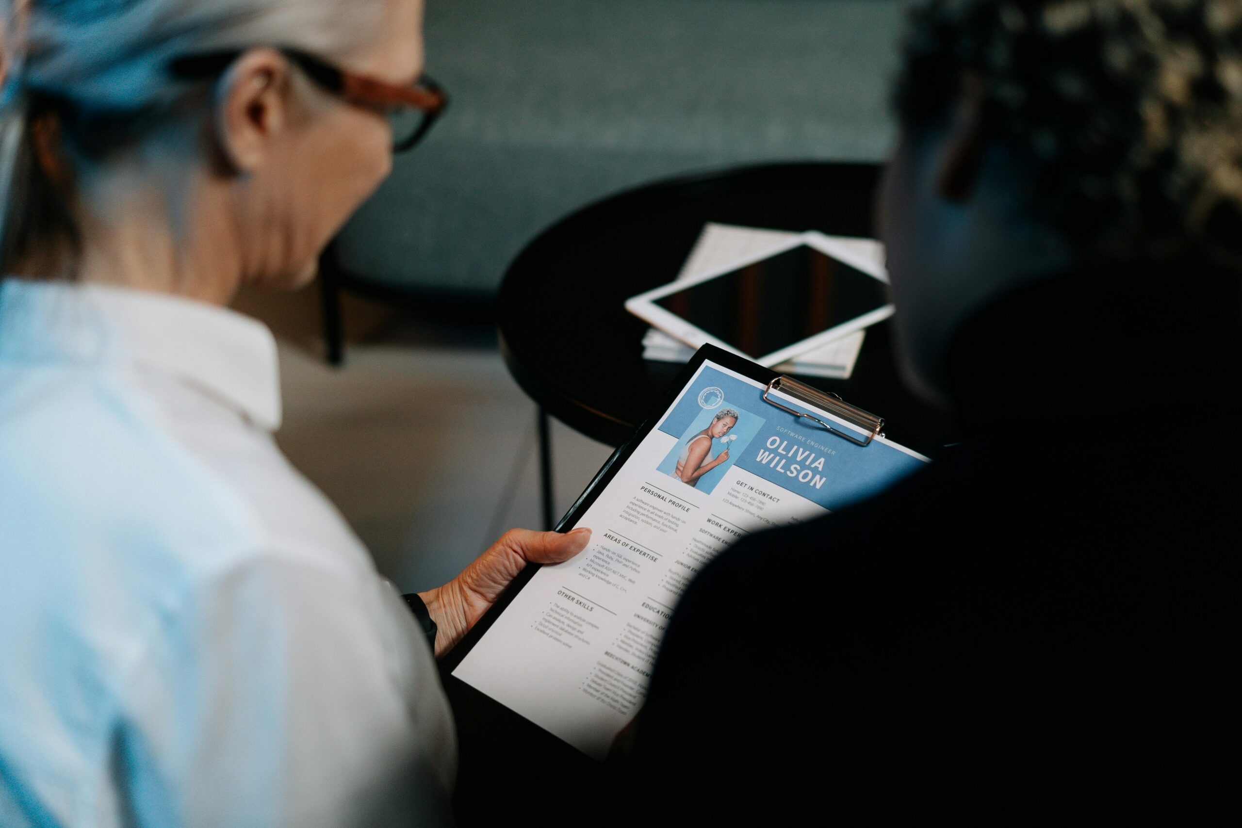 Free AI resume builder enhancing ‘Olivia Wilson’s’ resume presentation during a professional review.