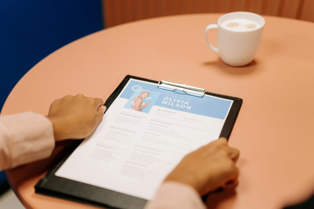 Close-up of a well-structured resume on a clipboard, showcasing a professional summary generated for effective job application.