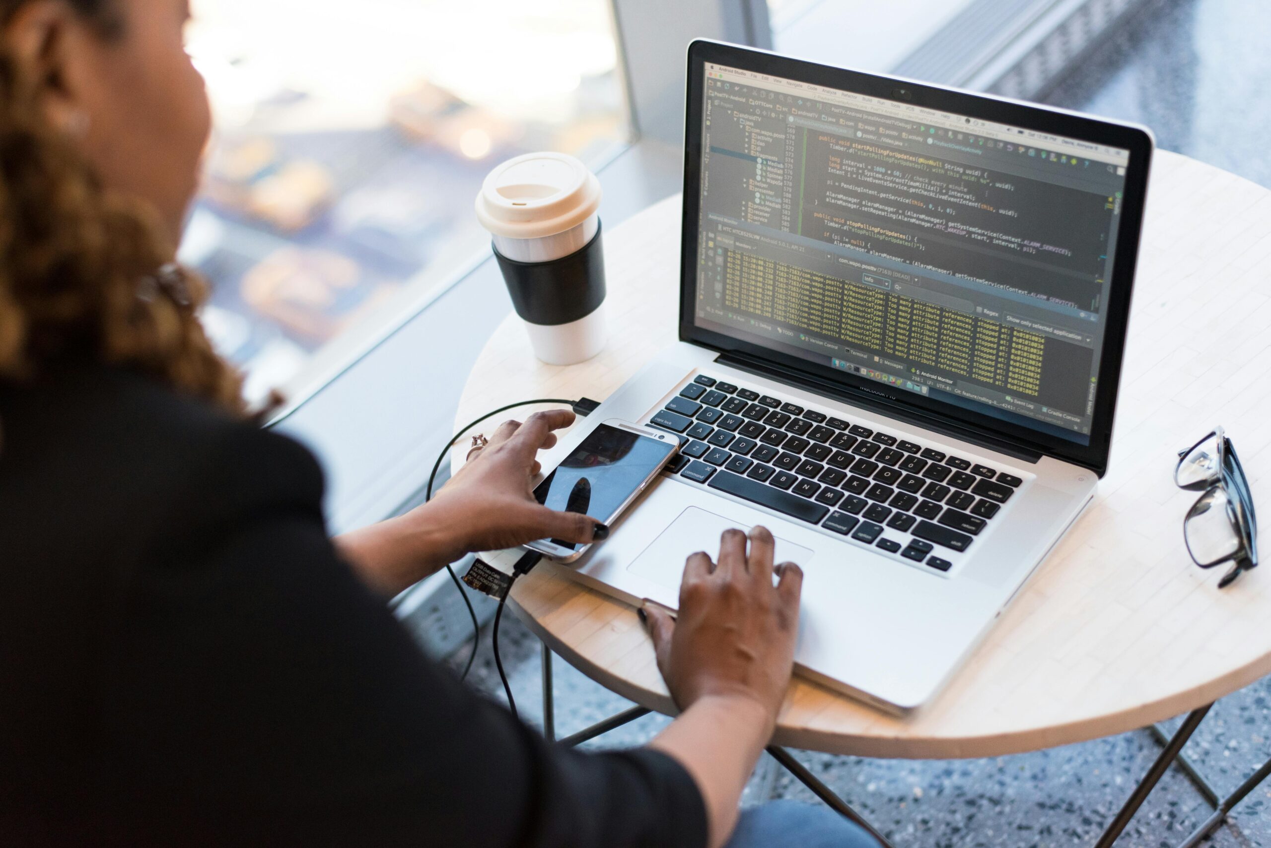 Professional working on a laptop in a modern setting, illustrating the efficiency of nearshore software development companies.
