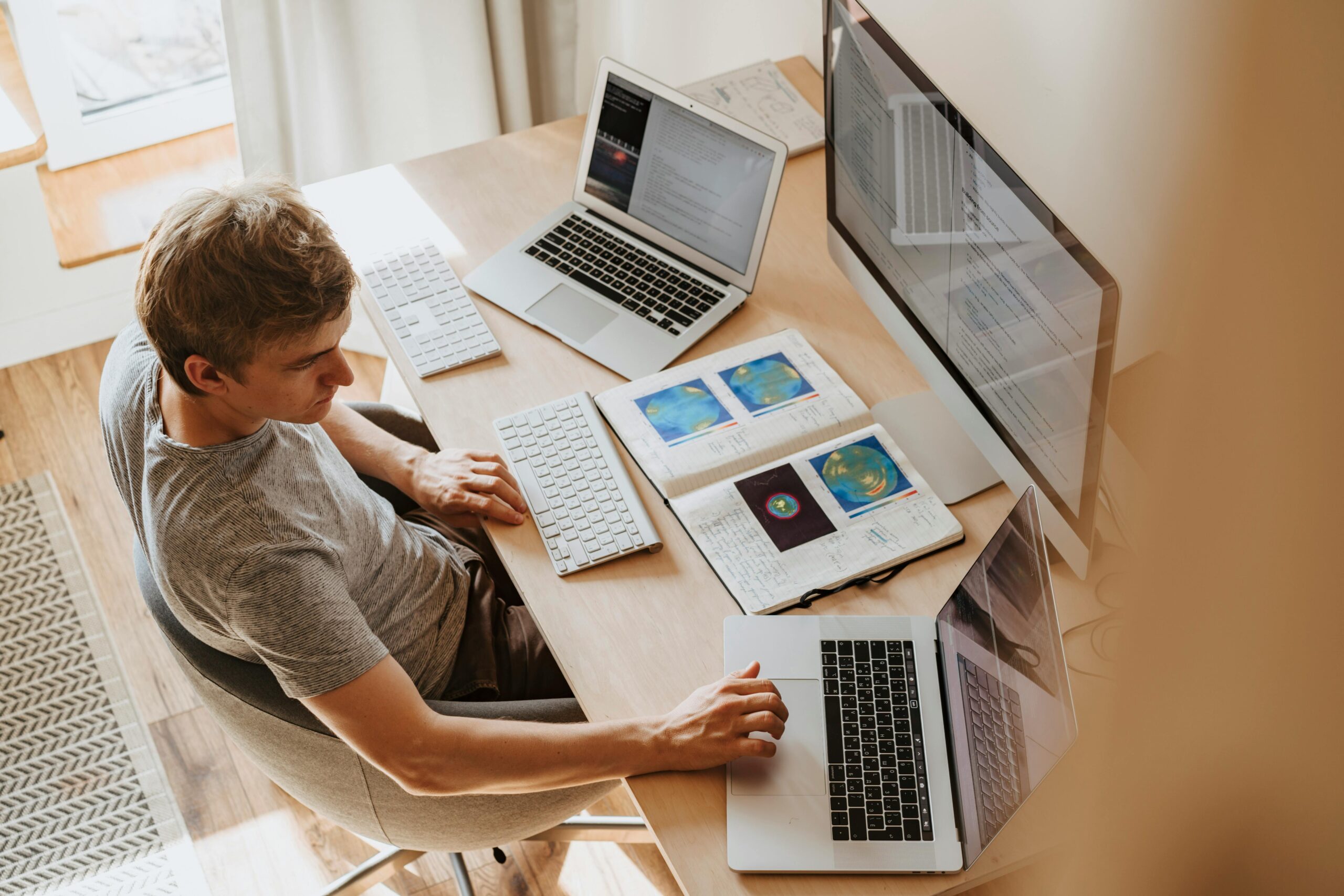 A developer working with dual screens in a well-lit home office.