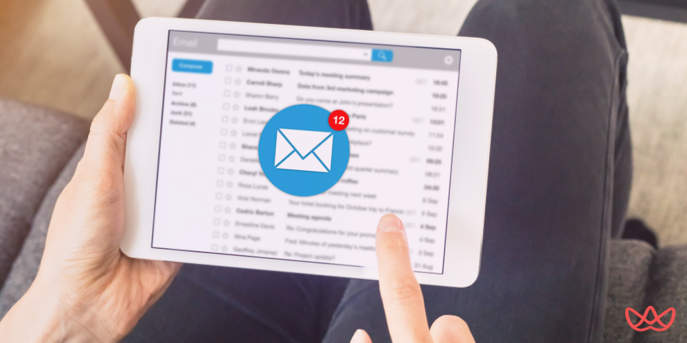 A close-up of a person checking email notifications on a tablet, representing the efficiency of email marketing outsourcing for businesses.