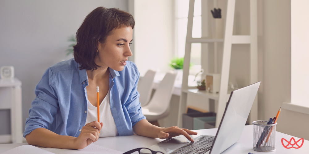 A professional woman working on a laptop at her desk, symbolizing the efficiency of an executive assistant for hire.