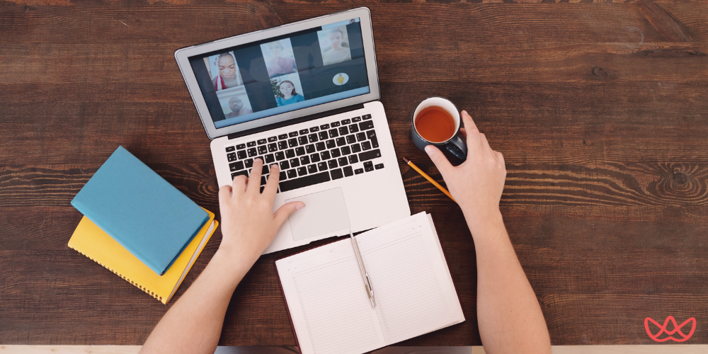 Top-down view of a virtual assistant attending a video call, showcasing strong virtual assistant qualities like time management and organization.