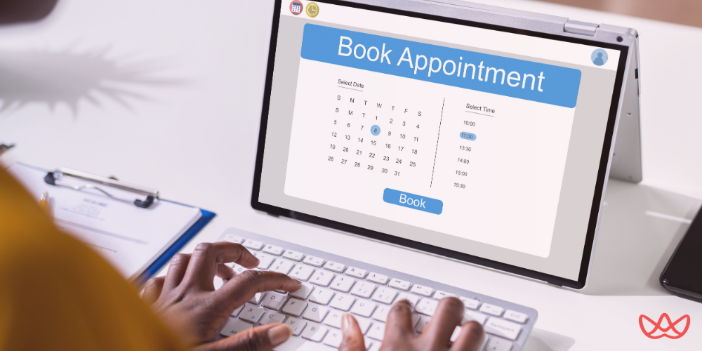 An appointment setter scheduling a meeting using an online booking system on a tablet.