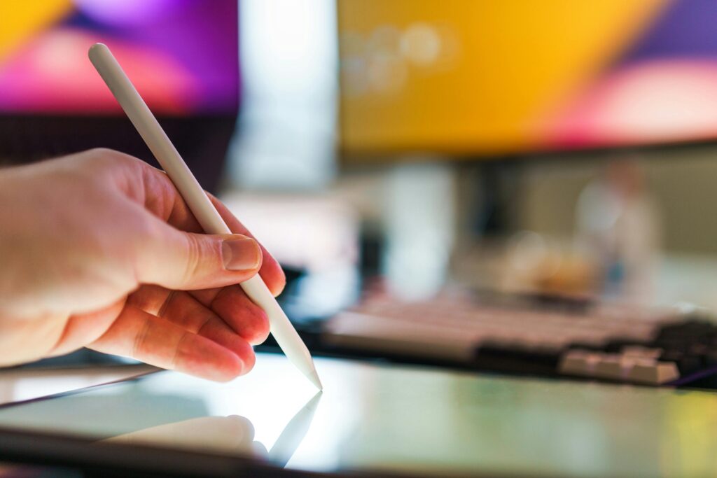 Close-up of a digital pen on a tablet, highlighting the tools used in graphic artist hire processes.