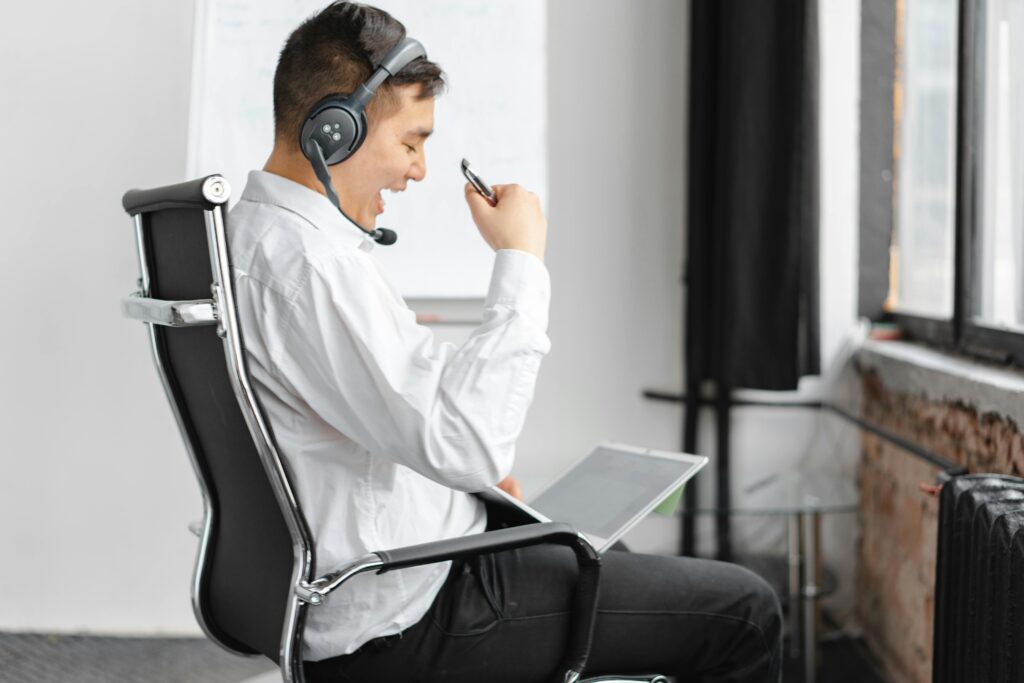 A professional with a headset engaging in a virtual meeting, demonstrating effective communication as one of the benefits of offshore outsourcing.