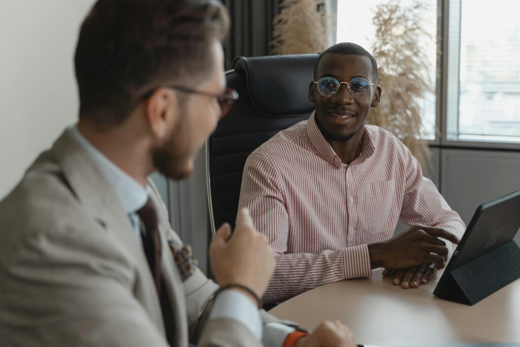 Two professionals in a face-to-face discussion about what to look for when hiring someone, focusing on key candidate traits.