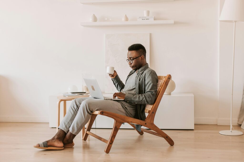 A professional working remotely on a laptop in a minimalistic setting, highlighting the flexibility and skills a marketing hire can bring to your team.