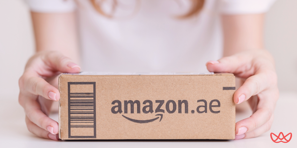 Hands holding an Amazon.aepackage, representing the importance of understanding key skills for an Amazon FBA consultant.