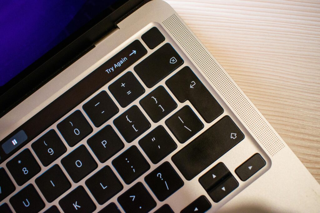 Close-up view of a laptop keyboard with a focus on the "Try Again" key, highlighting the importance of precision and attention to detail, essential skills for a link building specialist key skills summary.
