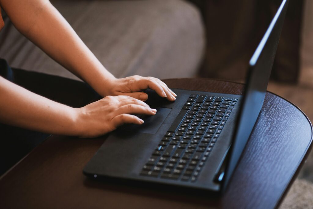 PPC specialist key skills summary: Hands typing on a laptop keyboard.