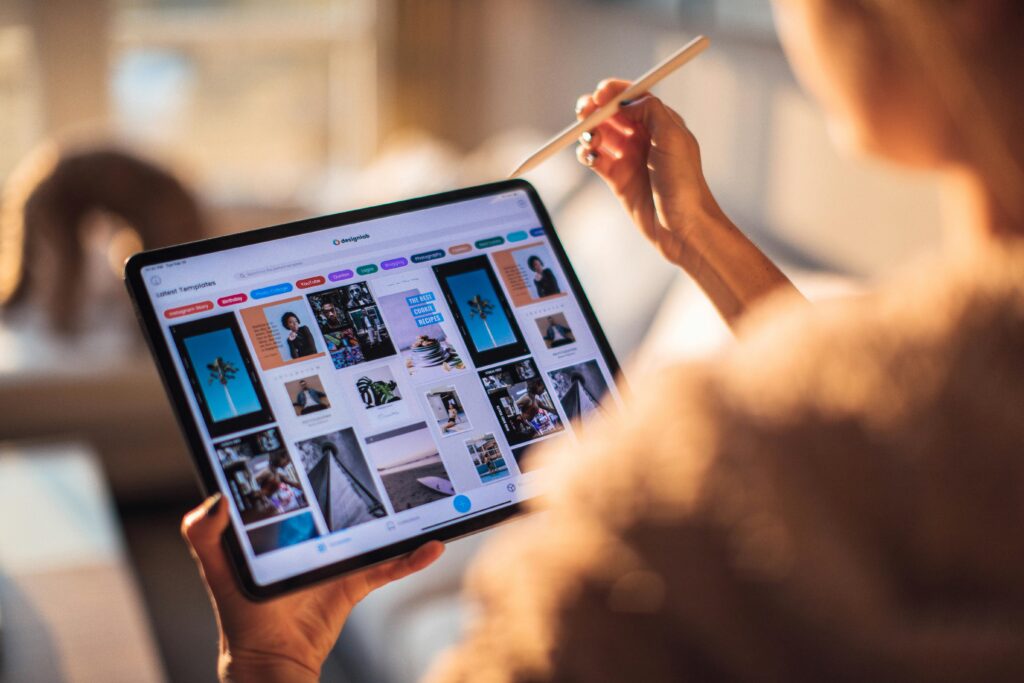 A person holding a tablet displaying design work with a stylus in hand, illustrating digital product designer key skills summary through interaction with digital tools.
