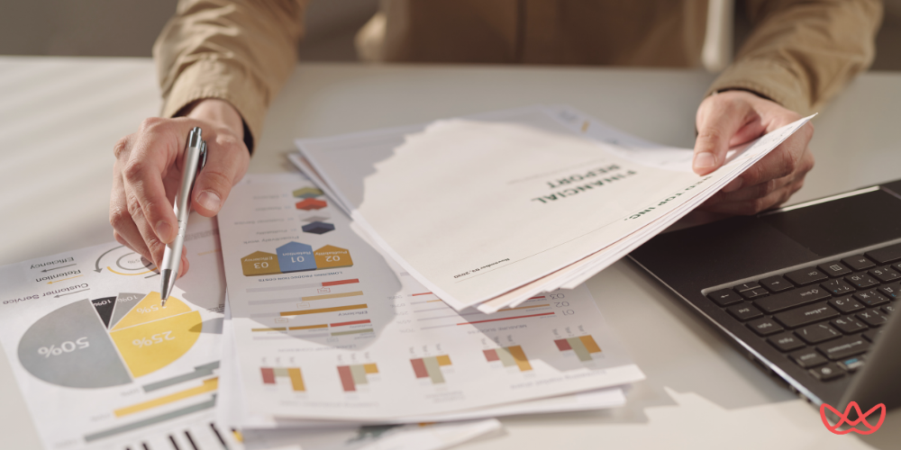Performance marketing director key skills summary illustrated through financial report review at a desk.