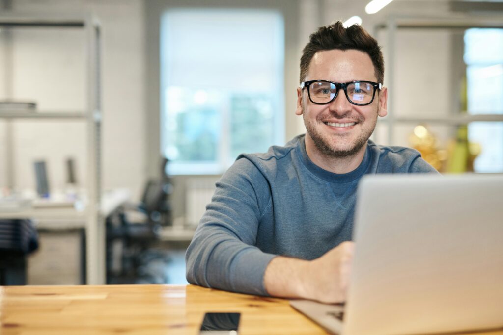 SEO specialist analyzing data on a laptop in a bright office environment.