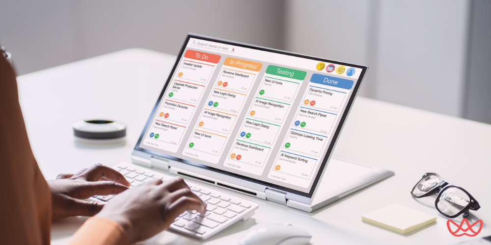 A person working on a laptop showcasing an Agile Project Manager Resume Template, organized with clear task columns labeled To Do, In Progress, Testing, and Done.