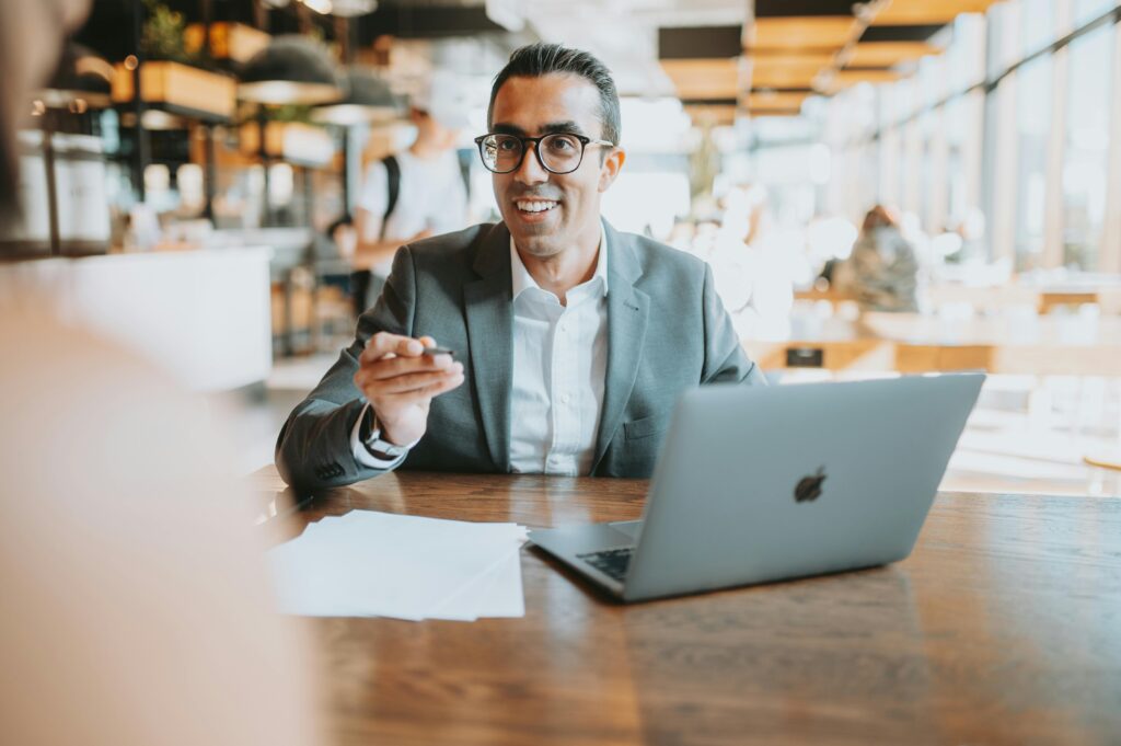 A confident business professional engaged in a discussion, representing strong client relationship skills—ideal for a Client Success Manager Resume Template.