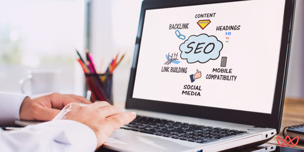 Professional reviewing SEO strategy diagram on laptop to outsource SEO reseller services.
