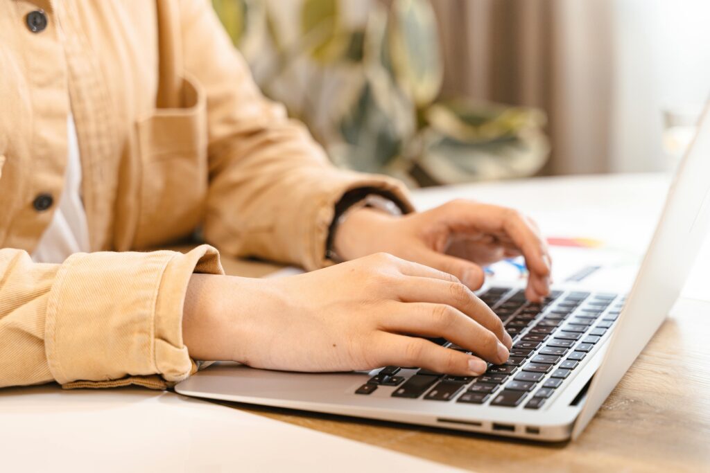 Professional working on laptop researching why outsourcing SEO can fail in warm office setting.