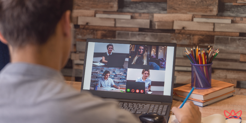 A person participating in a virtual meeting with four other professionals on their laptop, with a title card on the screen that reads "Top CFO Executive Search Firms in 2025."